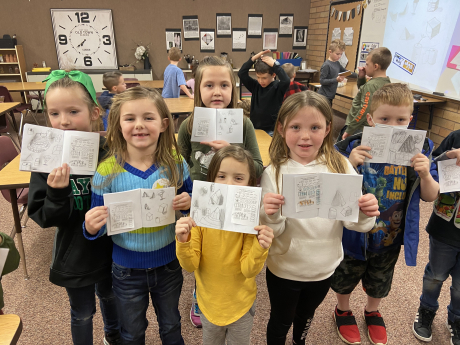 First graders displaying their sketch books