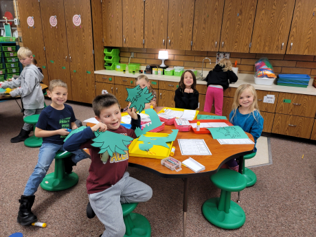 First Graders pose with their crafts