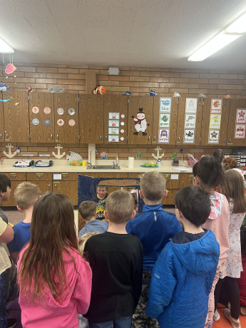 1st graders stand to see the details of the show