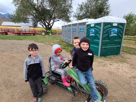 Students play on tractors at Rowley's Red Barn