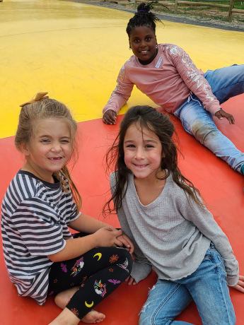 Students playing on the slide at Rowley's Red Barn