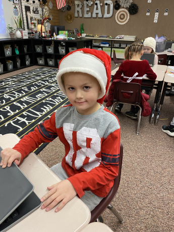 A student in his Santa hat