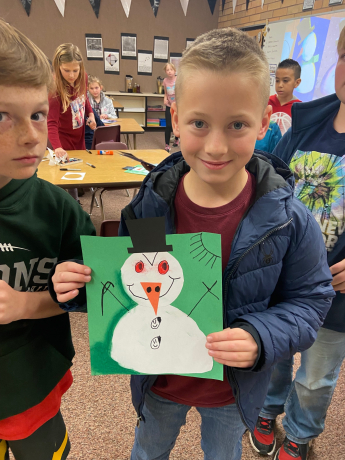 4th Grade boy with his unique snowman