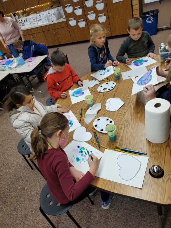 students painting hearts for Valentine's Day