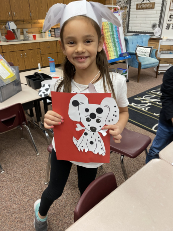 Student shows off her Dalmatian puppy artwork