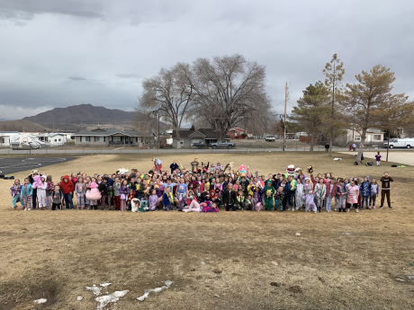 A large group of students pose for a picture at recess in their pajamas