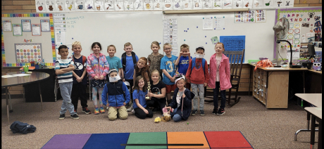 Mrs. Ostler's class poses with the Spirit Friday trophy