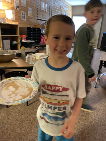 A student smiles with his pancake