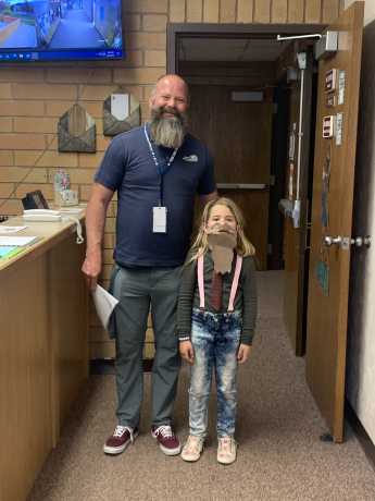 A student dressed up like Mr. Richins poses with the man himself