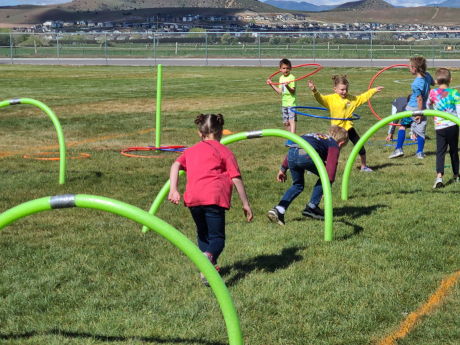Students running through the fun run obstacle course