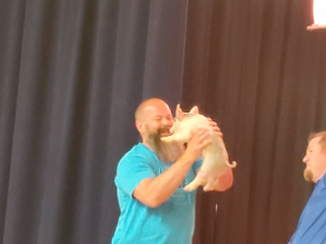 Mr. Richins kissing a pig