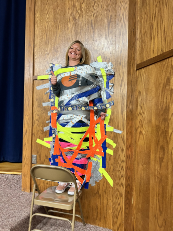 Mrs. Hermansen duct taped to the wall