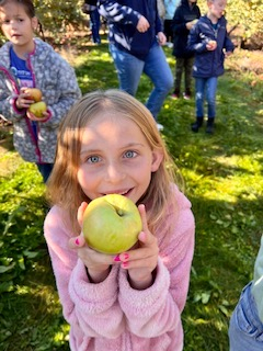 A student holds out an apple 