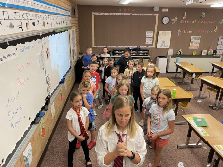 Mrs. Despain poses with Mrs. Provstgaard's 2nd graders to show off their ties and their silliest faces.