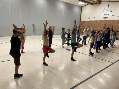 students practicing a yoga pose