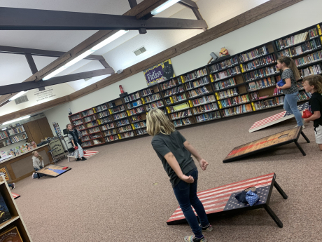 4th graders playing corn hole in the library