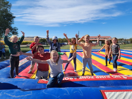Students pose on the bounce house