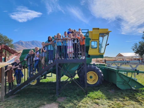 Mrs. Sumens's class poses on a tractor