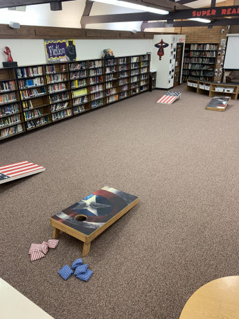 The corn hole boards all set up in the library 