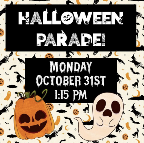 A sign with parade info: Halloween Parade Monday Oct 31 at 1:15 pm