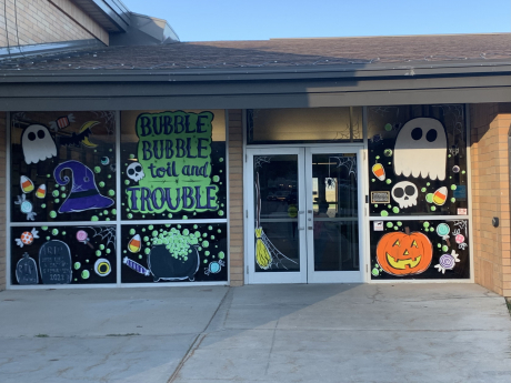 The windows of the school painted with Halloween designs