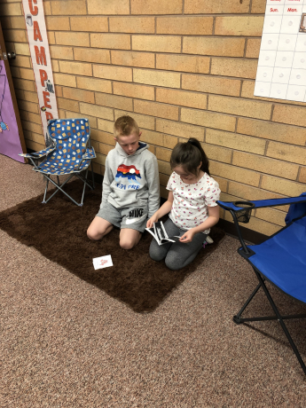 2 students read a book together
