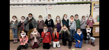 Second Graders pose with beards they made for Mr. Richins
