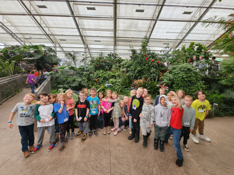 1st Graders pose at the butterfly biosphere