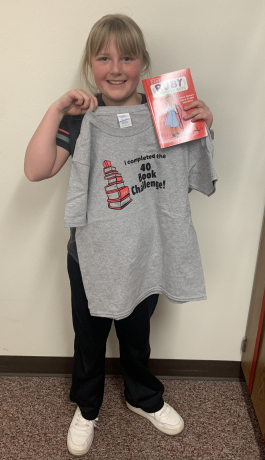 Gracie poses with her new book and t shirt