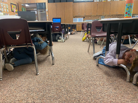 Students under desks during the earthquake drill