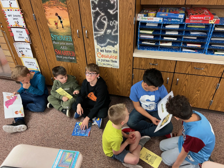 3rd graders reading to kindergarten students