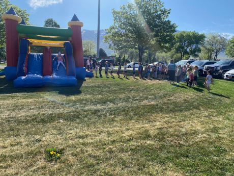 Kindergarten students lined up for the bounce house