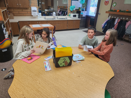 3rd graders reading with Kindergarteners