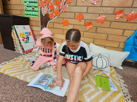 Two students read together