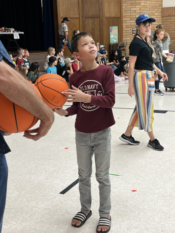 A boy checks out the hoop before taking his shot