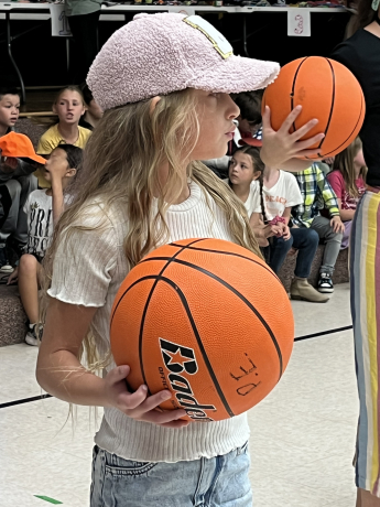 A student poses with a basketball