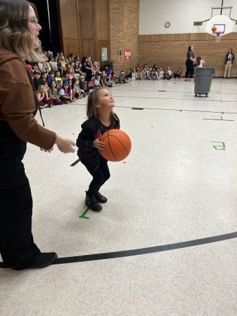 1st grade girl shooting a basketball
