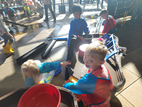 Students play at the water table
