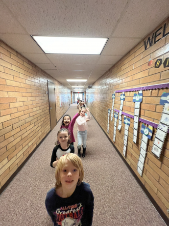 First graders walk the halls with their compasses