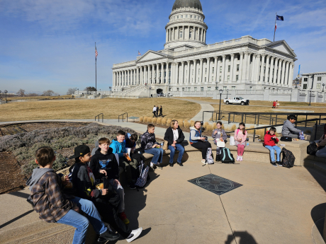 students sit outside the utah state capitol